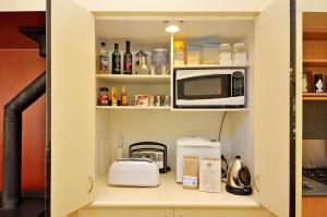 a kitchen pantry with a microwave and a toaster at Tree Elle Retreat in Bow Bridge