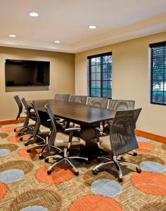 a conference room with a table and chairs at Staybridge Suites - Charlotte Ballantyne, an IHG Hotel in Charlotte