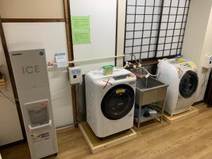 a washing machine and a dryer in a room at Ryokan Murayama in Takayama