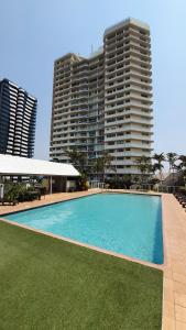 a large swimming pool in front of a tall building at Points North Apartments in Gold Coast