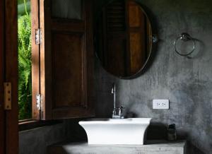 a bathroom with a white sink and a mirror at Casa El Cedro in Charalá