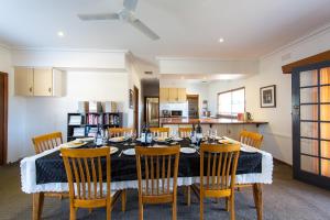 a kitchen and dining room with a table and chairs at Indigo Vineyard Farmstay in Beechworth