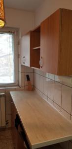 a kitchen with wooden cabinets and a counter top at Apartament Silva Busteni in Buşteni +14 photos