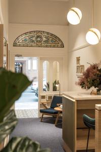 a lobby with a table and chairs and a stained glass window at The Jensen Potts Point in Sydney