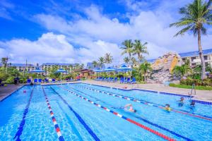 una piscina en un complejo con gente dentro en Pacific Islands Club Saipan, en Chalan Kanoa