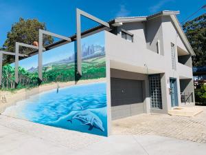 a painting of a swimming pool in front of a building at Huskisson Beach Resort in Huskisson