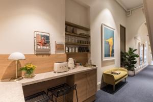 una stanza con una cucina con un bancone e una sedia di The Jensen Potts Point a Sydney