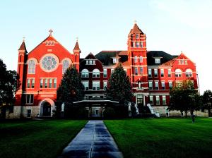 an orange building with a christmas tree in front of it at Holiday Inn Express Hotel & Suites Concordia US 81 by IHG in Concordia