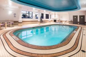 a large swimming pool in a hotel room at Holiday Inn & Suites Grande Prairie, an IHG Hotel in Grande Prairie