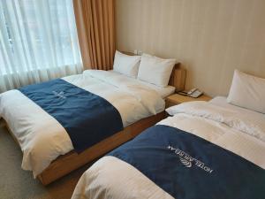 Postel nebo postele na pokoji v ubytování Incheon Aiport Airrelax hotel