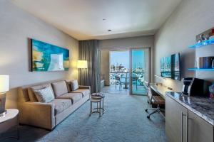 a living room with a couch and a table at Shade Hotel Redondo Beach in Redondo Beach