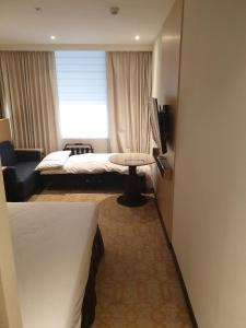 Postel nebo postele na pokoji v ubytování K Hotel Tianjin