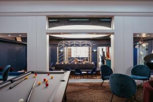 a room with a pool table and chairs at Grand Hôtel de Valenciennes in Valenciennes