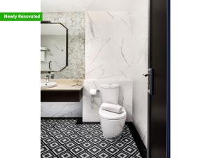 a bathroom with a toilet and a sink at Copthorne King's Hotel Singapore on Havelock in Singapore