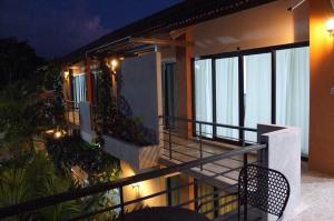 a balcony of a house with a view of the ocean at Wassana Sitdharma Guesthouse in Ban Na Pho