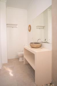 a bathroom with a sink and a toilet at The Palms Canggu in Canggu