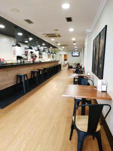 a restaurant with tables and chairs and a bar at Iraipe Izaga Hostal in Noáin