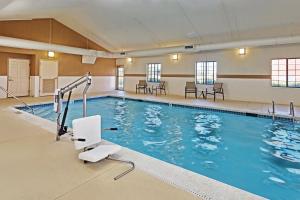 a pool in a hotel with chairs and tables at Staybridge Suites Glenview, an IHG Hotel in Glenview