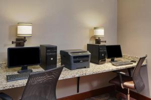 a desk with two computer monitors and a keyboard at Staybridge Suites Glenview, an IHG Hotel in Glenview