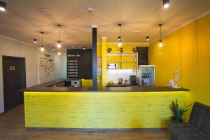 a yellow bar in a restaurant with a counter at DREAM Hostel Khmelnytskyi in Khmelnytskyi
