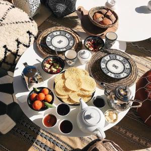 a table with food and a teapot on a table w obiekcie Riad SHIRAZ w Marakeszu