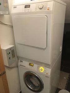a washing machine with a dryer in a bathroom at Alpinchalet Eder - Steiner in Saalbach-Hinterglemm