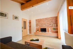 a living room with a couch and a tv at Apart Anna in Nauders