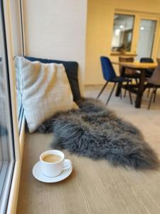 a cup of coffee sitting on the floor in a living room at Family house in Druskininkai