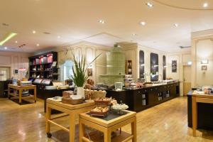 a large kitchen with wooden floors and counters at ACHAT Hotel Karlsruhe City in Karlsruhe