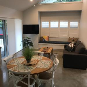 a living room with a table and a couch at Sawtell Beach Shack 1 in Sawtell