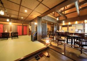 a room with tables and chairs and a dining room at Saikatei Jidaiya in Kaminoyama