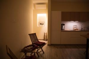 a chair in a room with a kitchen at JSK Suite in Rome