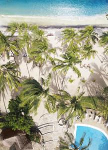 an aerial view of a beach with palm trees and a pool at Diamonds Dream of Africa in Malindi