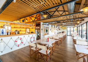 un restaurant avec des plafonds en bois, des tables et des chaises dans l'établissement YACHTER CLUB Modrá Čajka, à Dunacsún