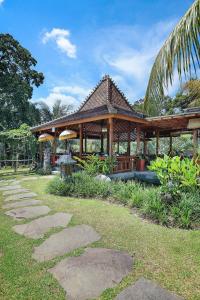 a pavilion with a pathway in front of it at Bucu View Resort in Ubud