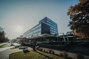 a tall building with a restaurant in front of it at Hotel Park Doboj in Doboj