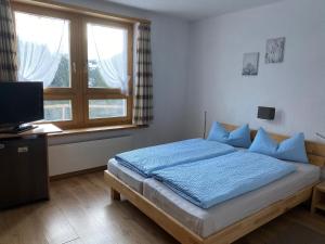 Postel nebo postele na pokoji v ubytování Gasthaus Edelweiss