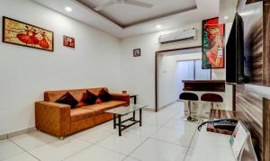 a living room with a couch and a table at Treebo Trend Saga Apartment in Bangalore