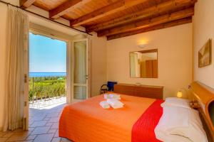 a bedroom with a bed with a view of the ocean at Residence Corte Ferrari -Ciao Vacanze- in Moniga