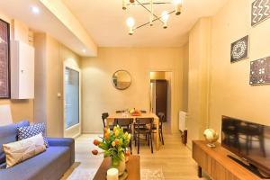 a living room with a blue couch and a table at 06 - Designed Flat Paris Grands Boulevards in Paris