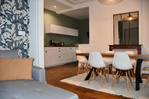 - une cuisine et une salle à manger avec une table et des chaises dans l'établissement Maison bourgeoise Haussmannienne - Gîtes de France, à Limoges