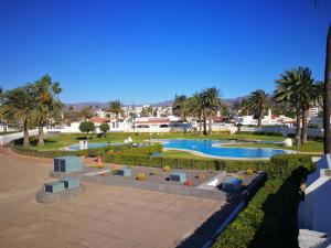 a resort with a swimming pool and palm trees at Cozy Luxury in San Bartolomé