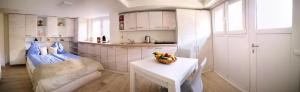 a kitchen with a table with a bowl of fruit on it at Rheintal Zentrum in Altach