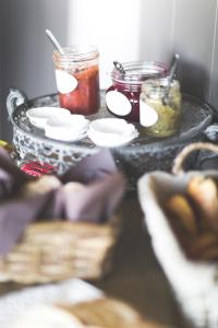 a table with jars of food on top of it at B&B Nieuwhof in Gistel