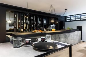 a kitchen with a table with two plates on it at The Duke Boutique Suites in Athens