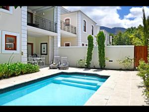 a swimming pool in front of a house at 10 Villefranche in Franschhoek