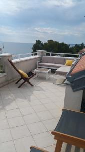 a patio with a couch and a hammock on a roof at Apartments Lucija in Zadar