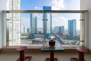 a table in front of a large window with a view of a city at Luxury Apartment Vinhomes Skylake in Hanoi