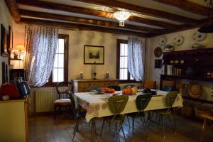 a dining room with a table and some chairs at Casa nel cuore del prosecco in Valdobbiadene