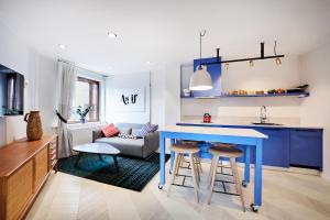 a kitchen and living room with a blue table and stools at Generator Stockholm in Stockholm